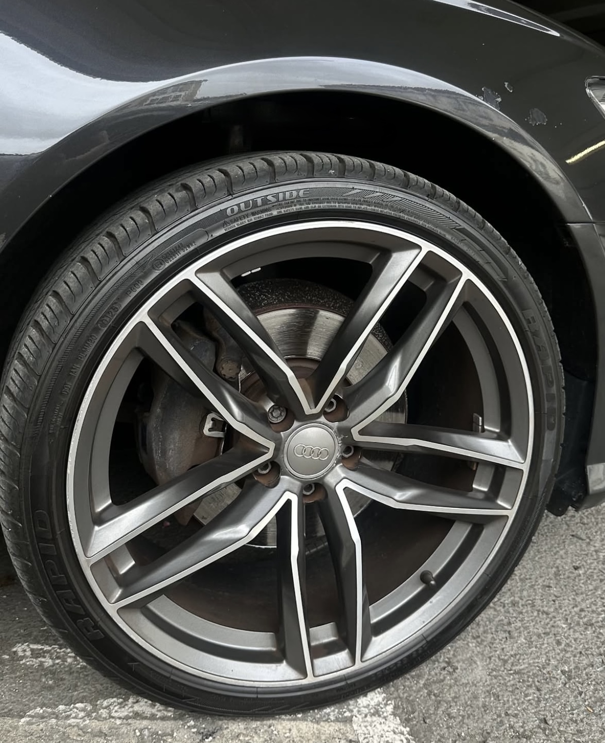 Audi wheel with unpainted brake caliper before painting